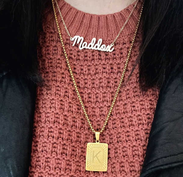 This is an image of our Cursive name necklace with our rectangle medallion neckalce